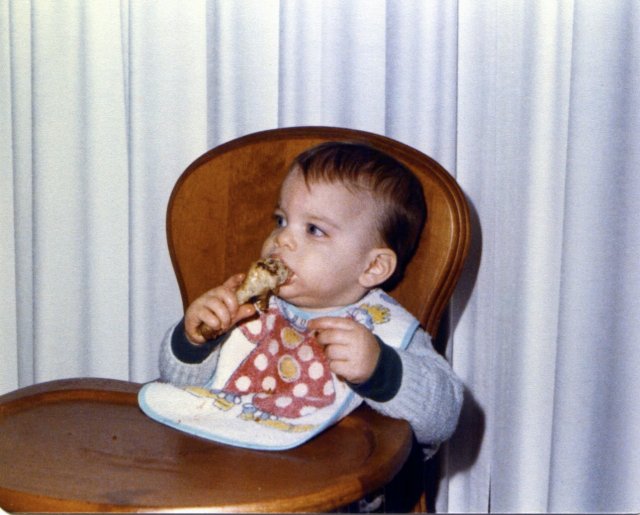 1977-12-10 Eating First Fried Chicken Leg.jpg