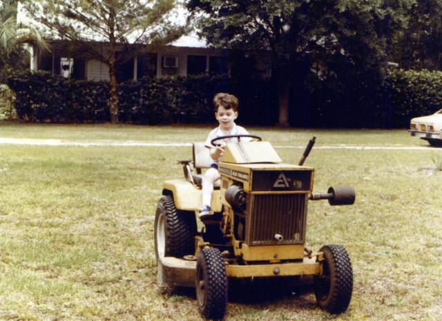 1980-05 driving Aunt Toot's tractor Welaka Florida.jpg