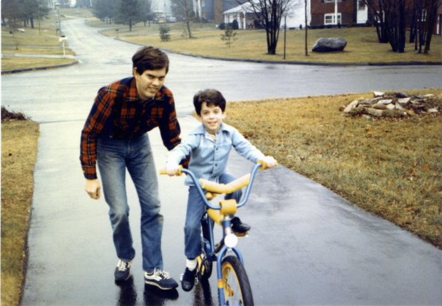 1982-12-25 Bill on bike with Dad.jpg